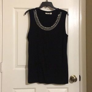 A black top with a white beaded neck line
